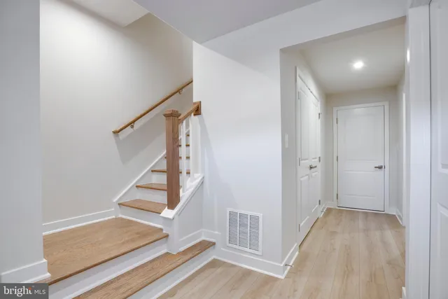 a view of entryway with wooden floor and door