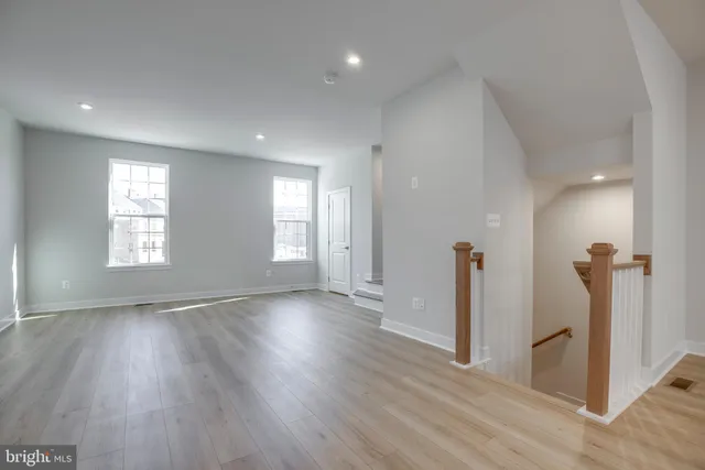 a view of a room with wooden floor and window