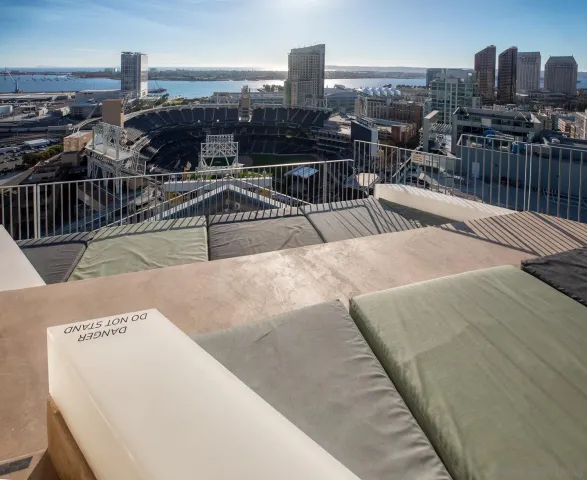 a view of a building with barbeque plants and trees