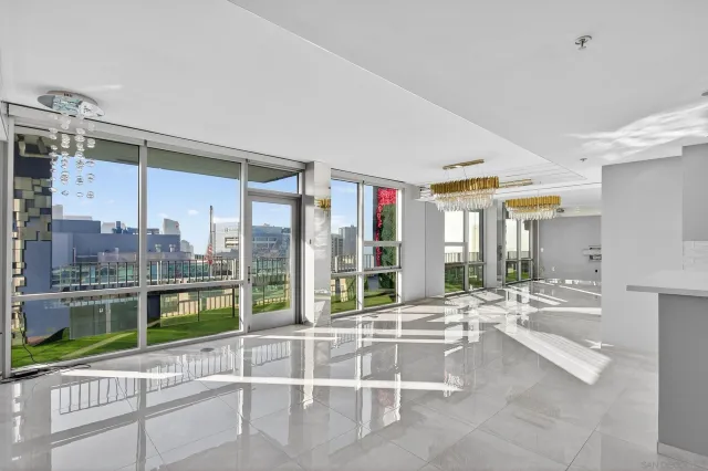 a room with a large window and a view of living room