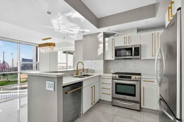 a living room with a large window and a counter space