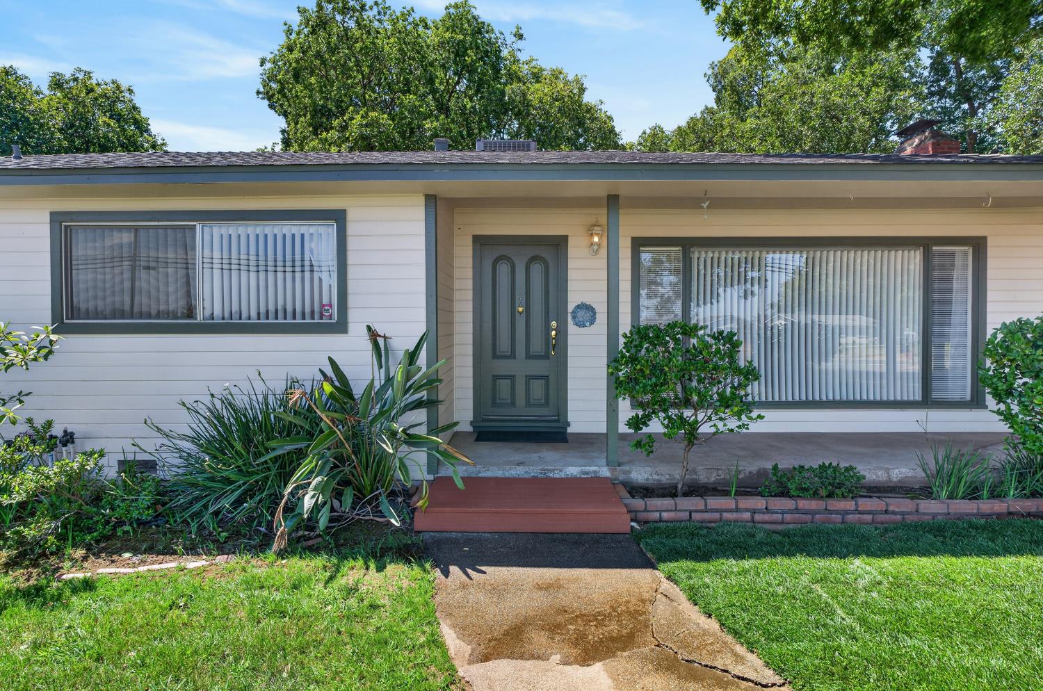 10700 Calvine Road Elk Grove, CA 95830 - Photo 9 of 73 a front view of a house with garden