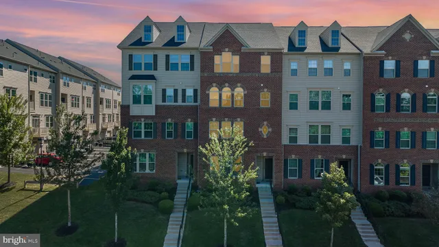 a front view of a residential apartment building with a yard