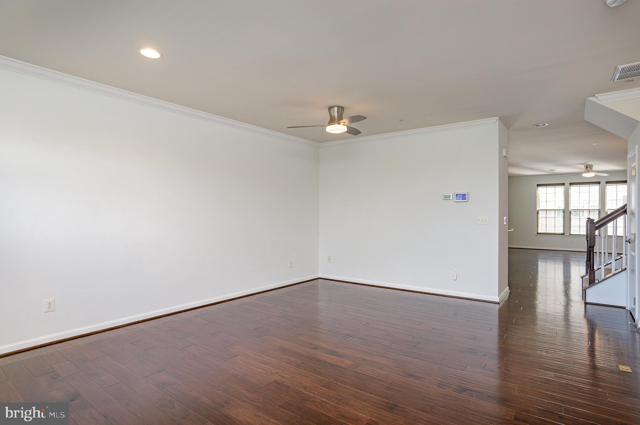 25890 Racing Sun Drive Aldie, VA 20105 - Photo 11 of 25 a view of an empty room with wooden floor and a window