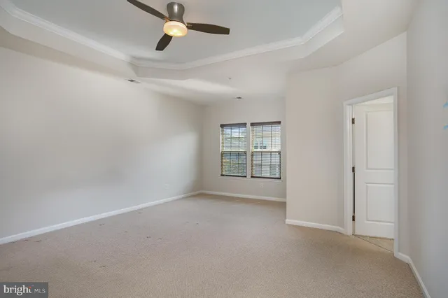 a view of an empty room with a ceiling fan