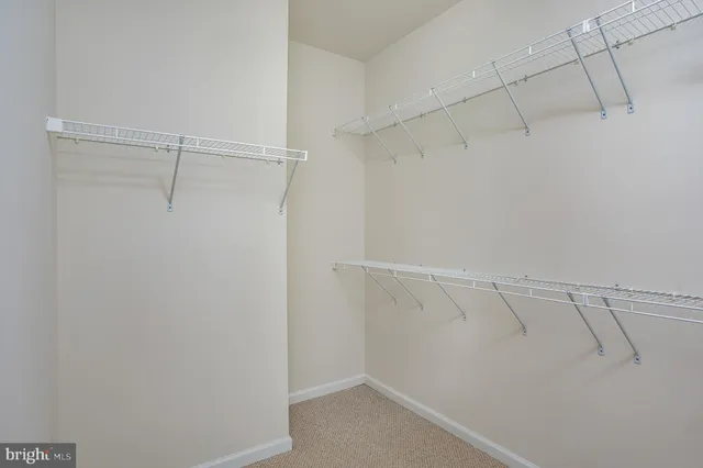a view of an empty room and a ceiling fan
