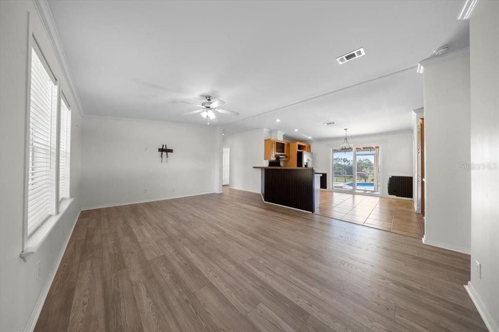 17355 Southeast 260th Avenue Road Umatilla, FL 32784 - Photo 12 of 69 a view of empty room with wooden floor