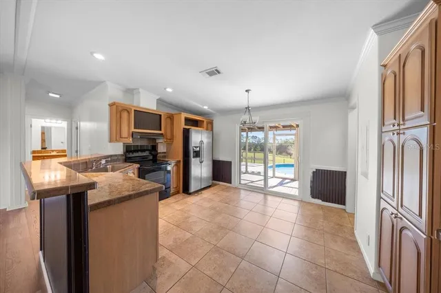 a kitchen with refrigerator and cabinets
