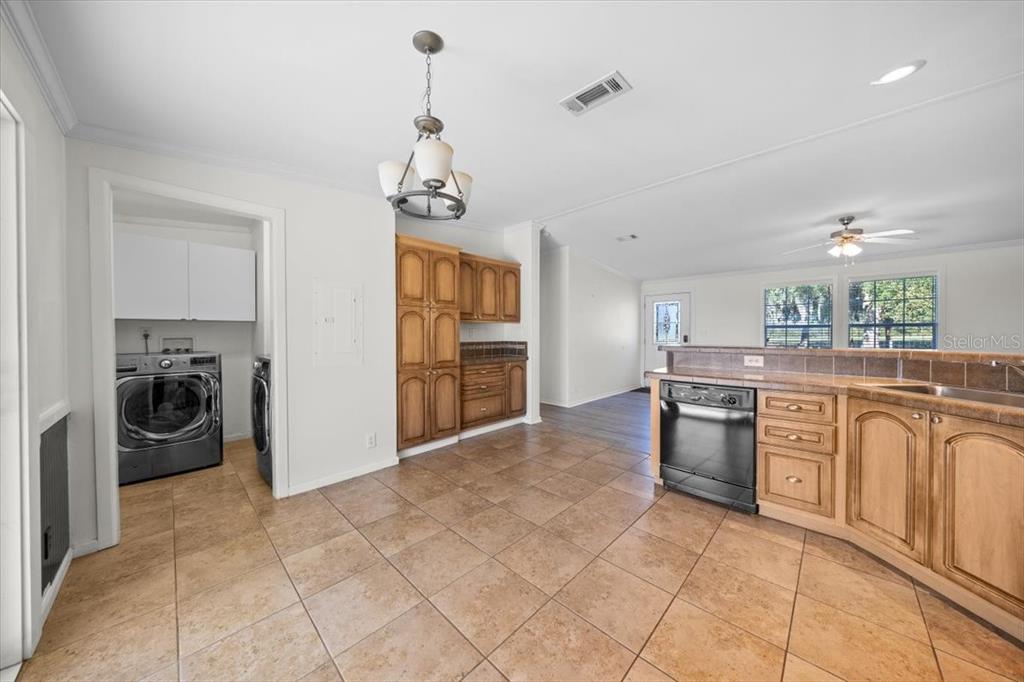 17355 Southeast 260th Avenue Road Umatilla, FL 32784 - Photo 17 of 69 a kitchen with refrigerator and cabinets