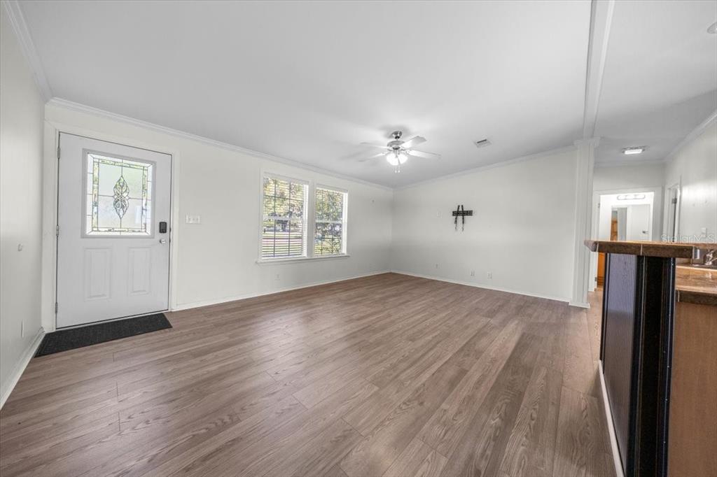 17355 Southeast 260th Avenue Road Umatilla, FL 32784 - Photo 19 of 69 an empty room with wooden floor cabinet and windows