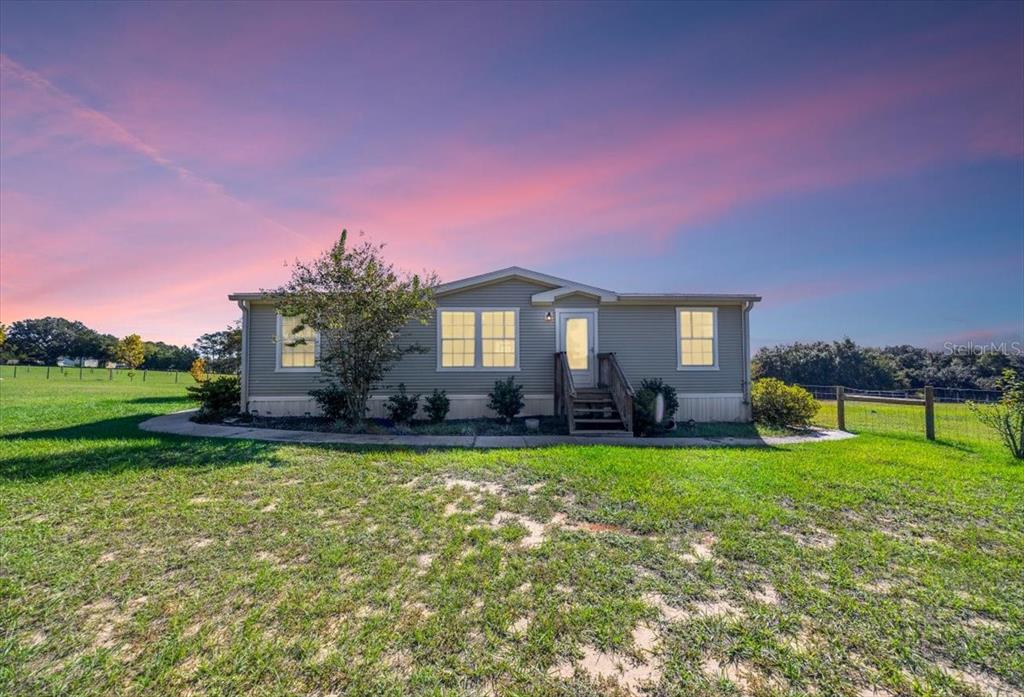 17355 Southeast 260th Avenue Road Umatilla, FL 32784 - Photo 2 of 69 a swimming pool with outdoor seating and yard