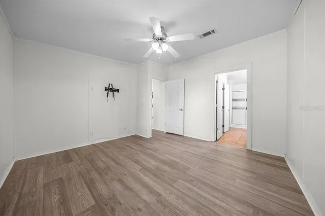 a view of walk in closet with empty racks