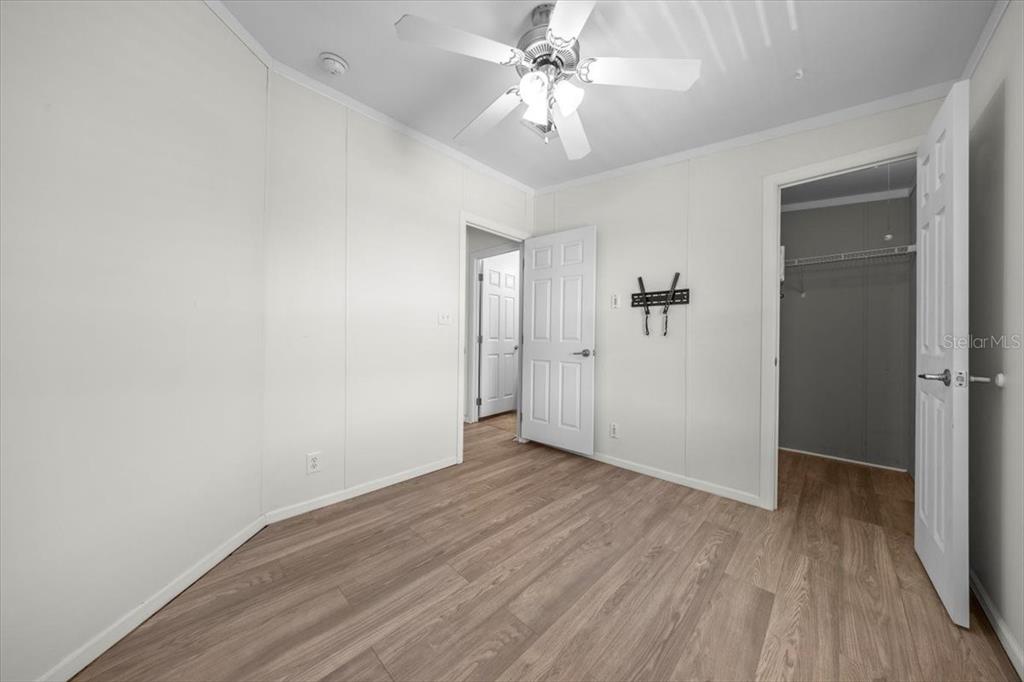 17355 Southeast 260th Avenue Road Umatilla, FL 32784 - Photo 26 of 69 a view of an empty room with wooden floor