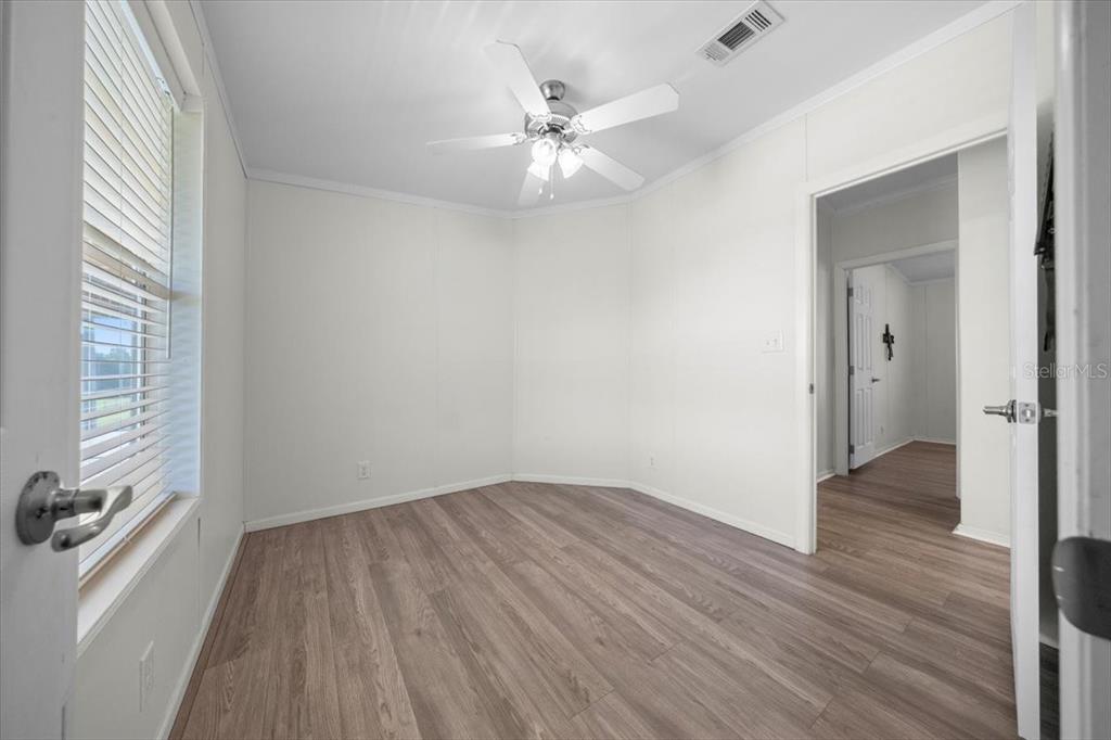 17355 Southeast 260th Avenue Road Umatilla, FL 32784 - Photo 27 of 69 wooden floor in an empty room with a window