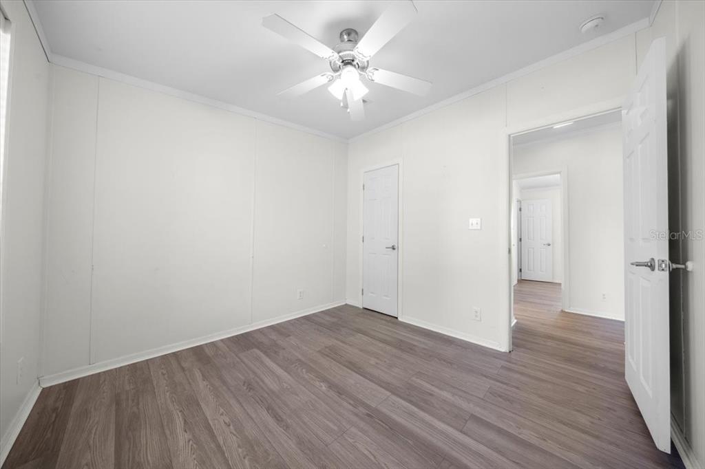 17355 Southeast 260th Avenue Road Umatilla, FL 32784 - Photo 28 of 69 a view of an empty room with wooden floor