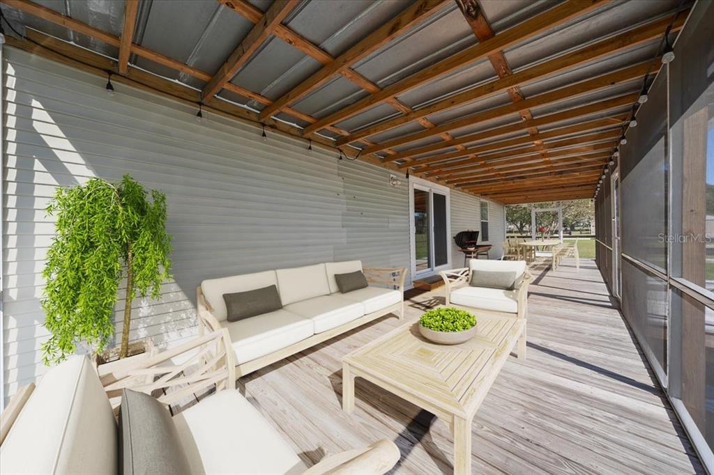 17355 Southeast 260th Avenue Road Umatilla, FL 32784 - Photo 33 of 69 a view of the patio with couches and potted plants