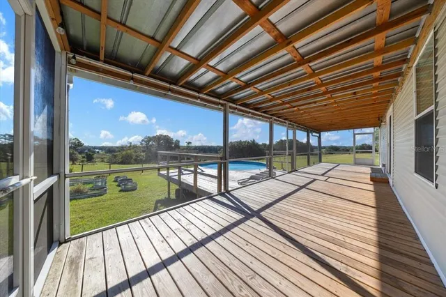 a view of a wooden deck with a yard