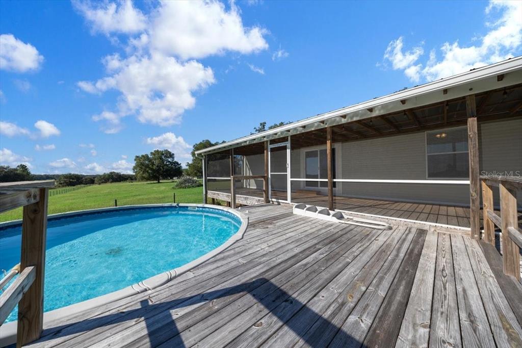 17355 Southeast 260th Avenue Road Umatilla, FL 32784 - Photo 38 of 69 a view of a wooden deck with a yard