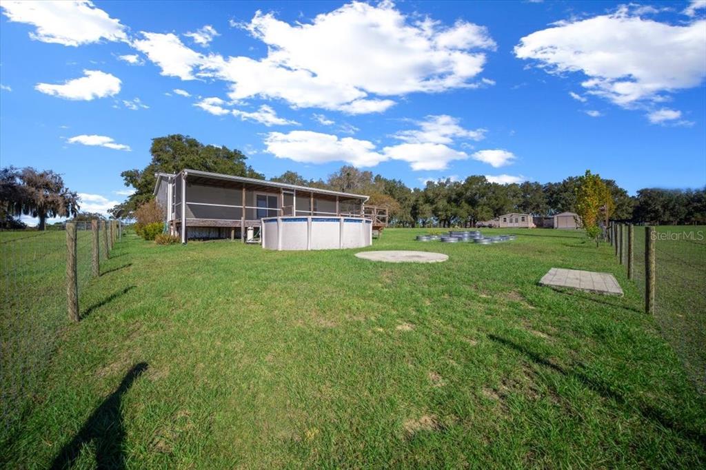 17355 Southeast 260th Avenue Road Umatilla, FL 32784 - Photo 43 of 69 a view of a house with a backyard