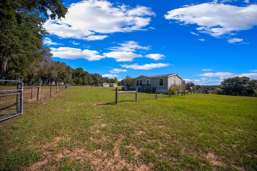 17355 Southeast 260th Avenue Road Umatilla, FL 32784 - Photo 5 of 69 a view of a playground with basketball court