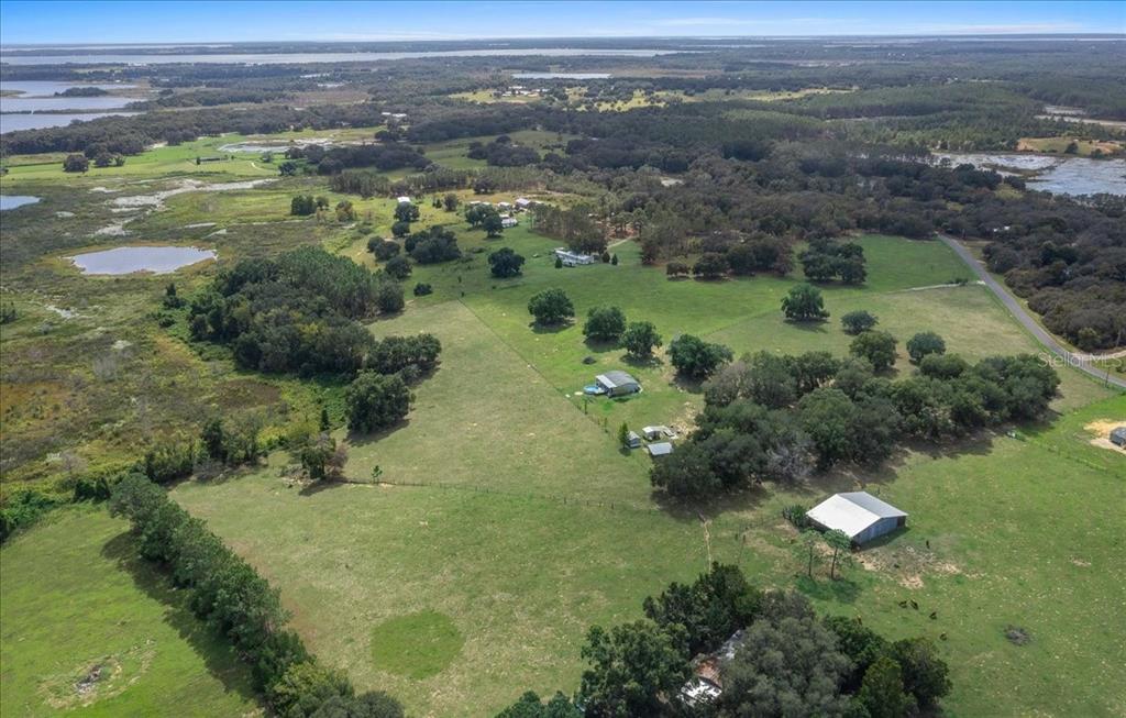 17355 Southeast 260th Avenue Road Umatilla, FL 32784 - Photo 52 of 69 a view of a lake with a yard