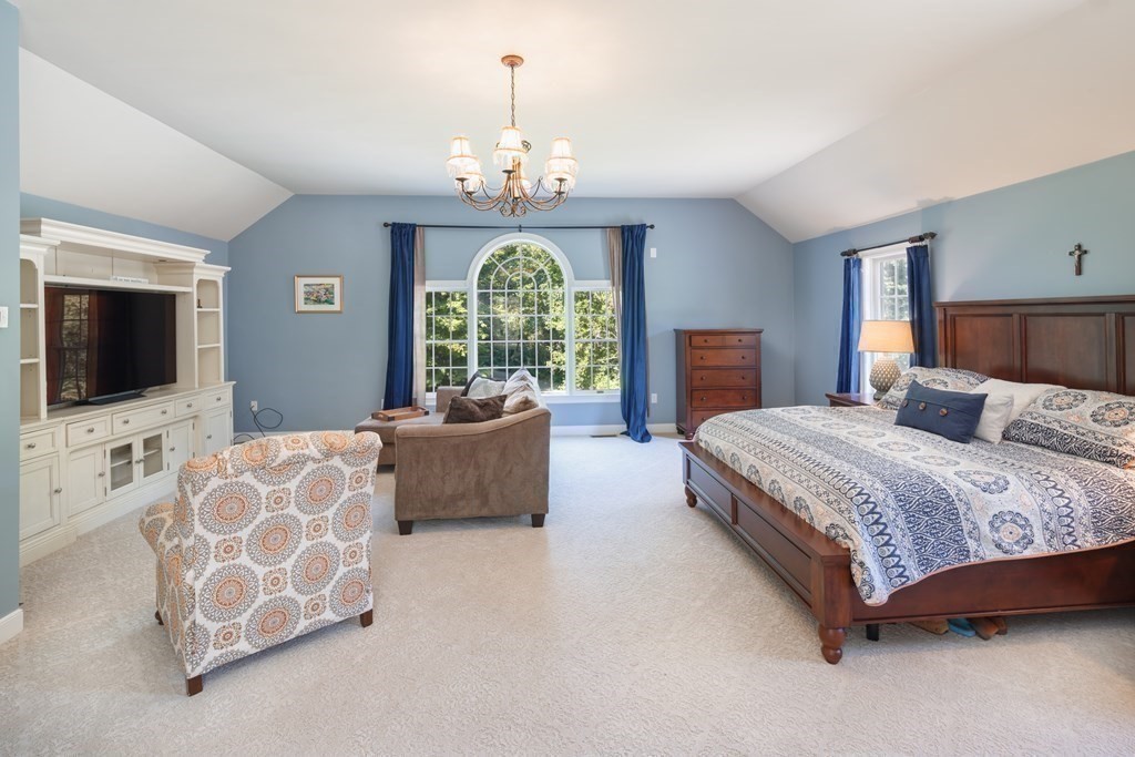 29 Anne Road North Andover, MA 01845 - Photo 15 of 31 a spacious bedroom with a bed and a flat screen television