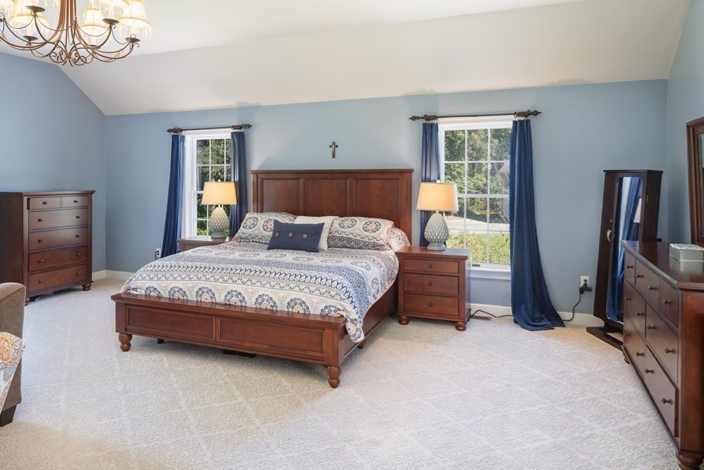 29 Anne Road North Andover, MA 01845 - Photo 16 of 31 a bedroom with a bed a chandelier and dresser