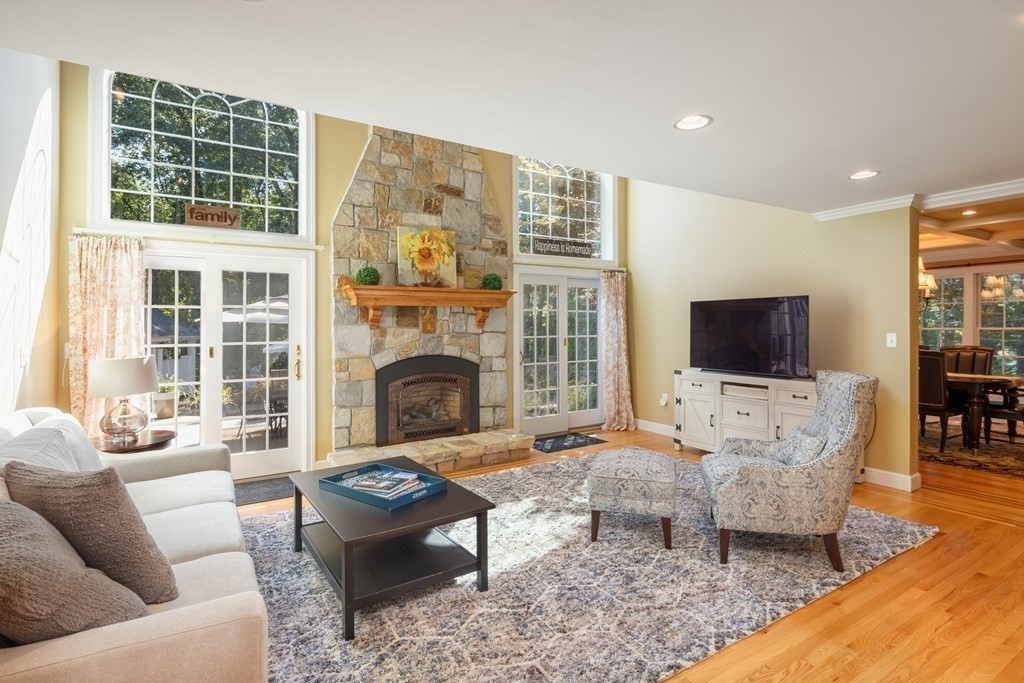 29 Anne Road North Andover, MA 01845 - Photo 9 of 31 a living room with furniture a flat screen tv and a fireplace