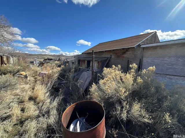 a view of a house with a small yard and wooden fence