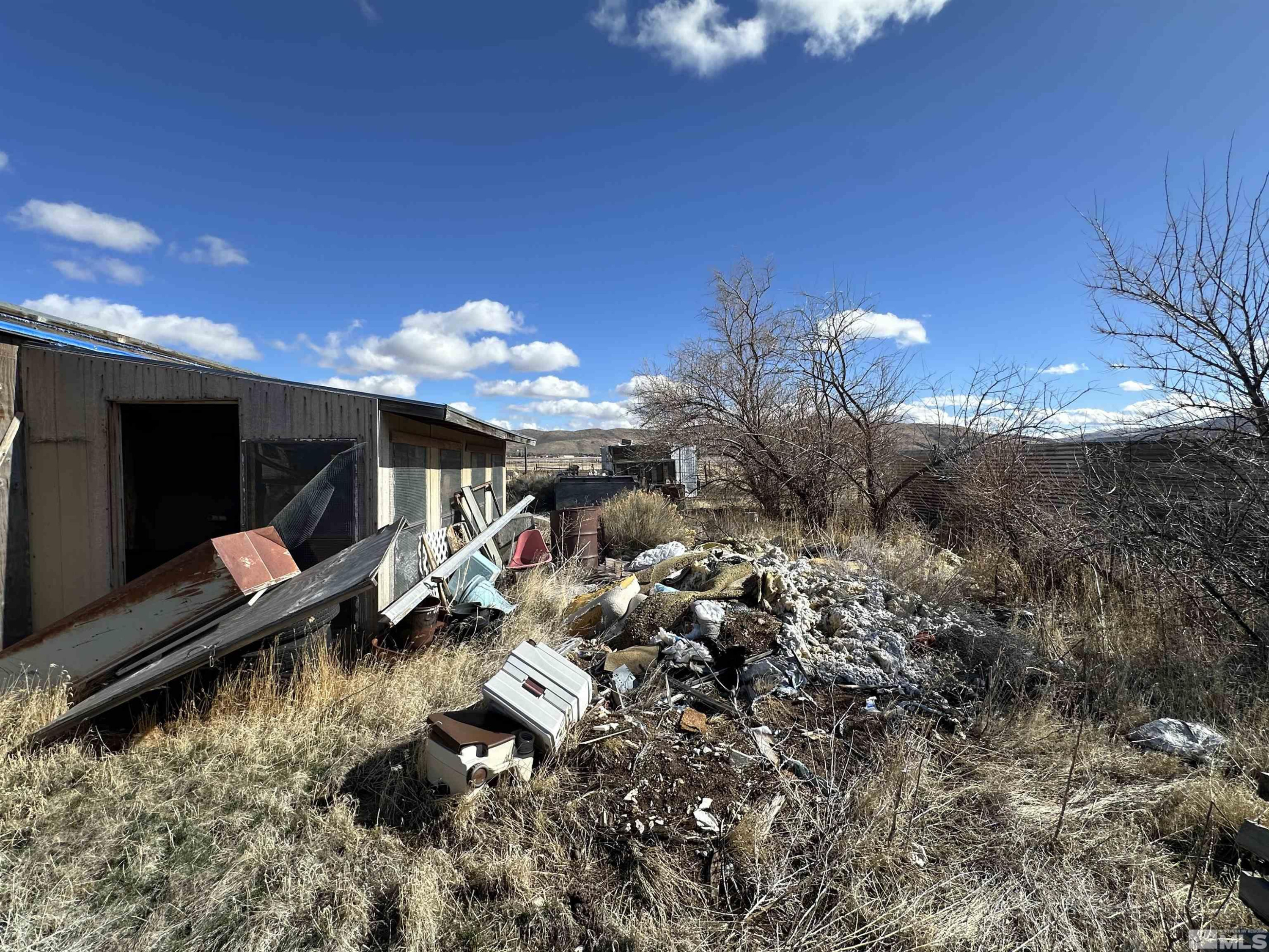 17605 West Aspen Circle Reno, NV 89508 - Photo 13 of 19 a view of a house with a yard fire pit and a wooden fence