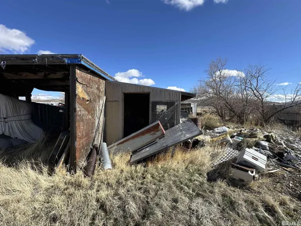 a backyard of a house with table and chairs