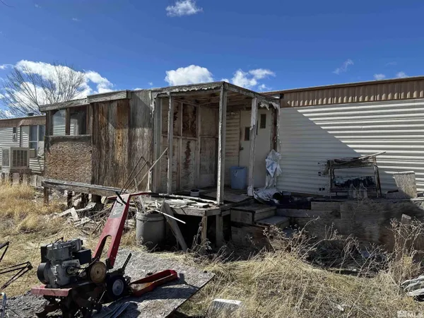 a view of a chairs and table in backyard