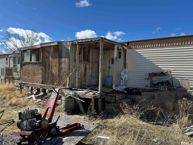 a view of a chairs and table in backyard