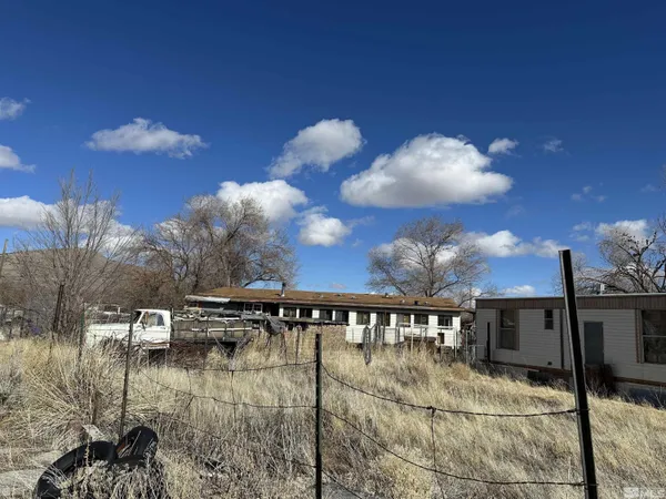 a view of a swimming pool with a table and chairs