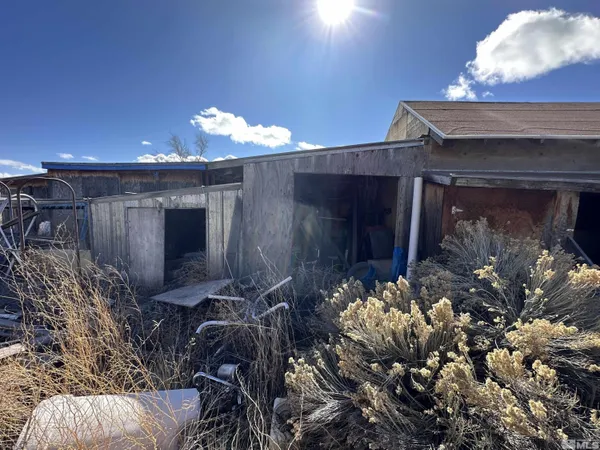 a room with water heater and wooden walls
