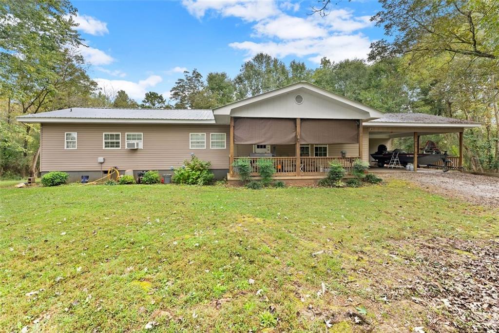 6668 Belton Bridge Road Lula, GA 30554 - Photo 2 of 20 a backyard of a house with yard and outdoor seating