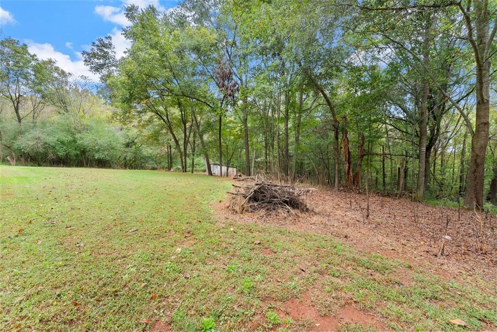 6668 Belton Bridge Road Lula, GA 30554 - Photo 6 of 20 a view of a field with a tree