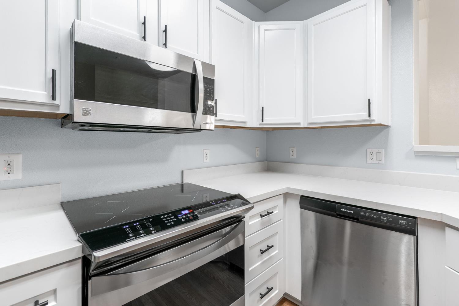 1900 Danbrook Drive, Unit 1222 Sacramento, CA 95835 - Photo 13 of 51 a kitchen with a stove and a microwave