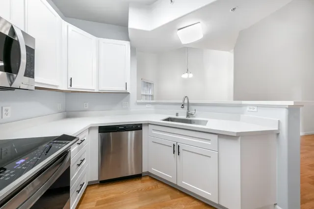 a kitchen with a sink stove and cabinets