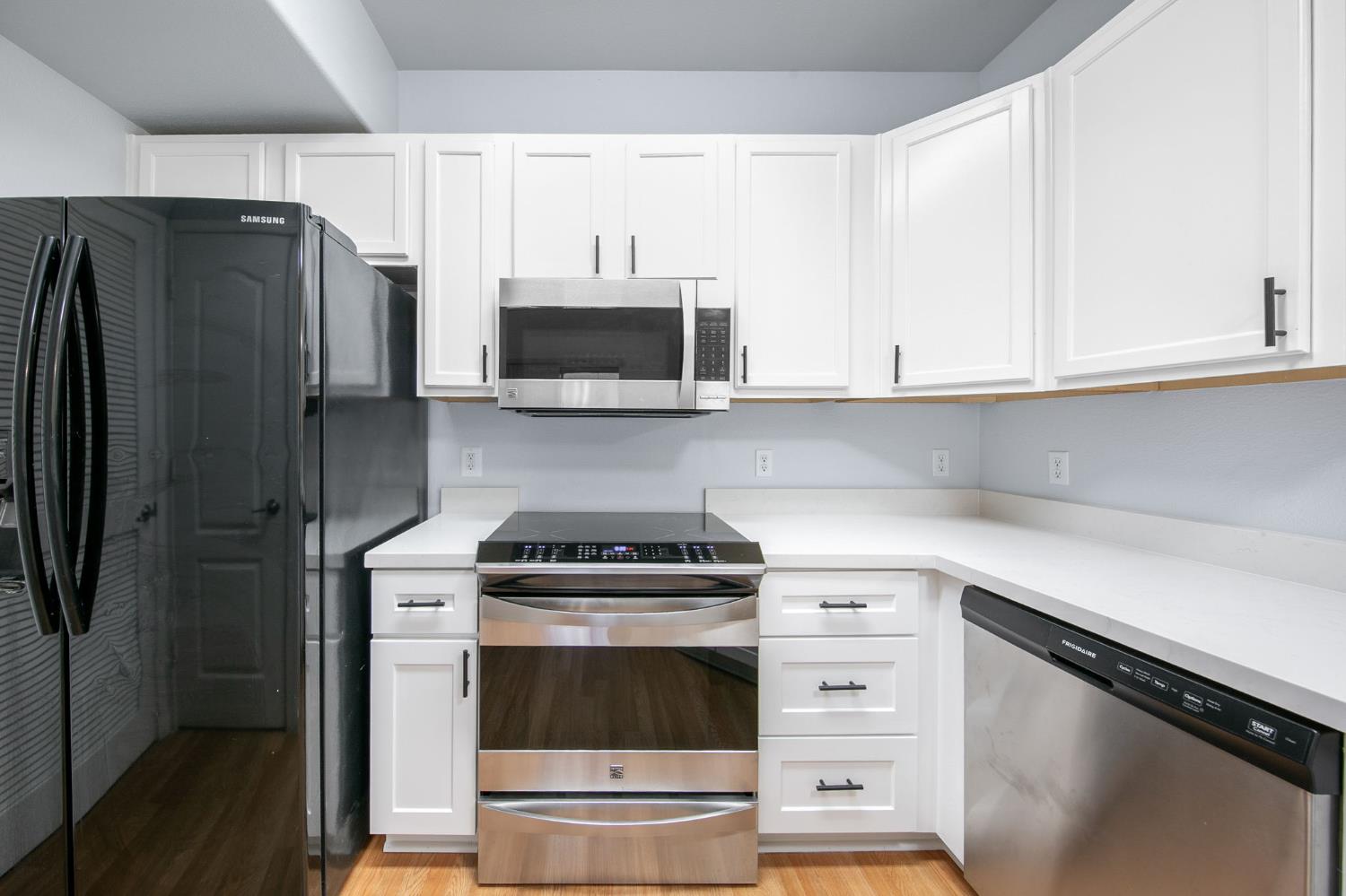 1900 Danbrook Drive, Unit 1222 Sacramento, CA 95835 - Photo 16 of 51 a kitchen with stainless steel appliances white cabinets and a stove a refrigerator with white countertops and cabinets