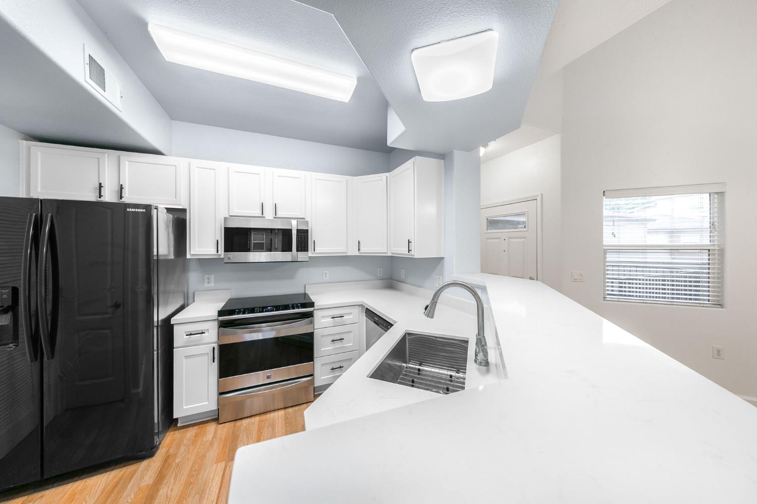 1900 Danbrook Drive, Unit 1222 Sacramento, CA 95835 - Photo 20 of 51 a kitchen with stainless steel appliances a refrigerator sink and microwave