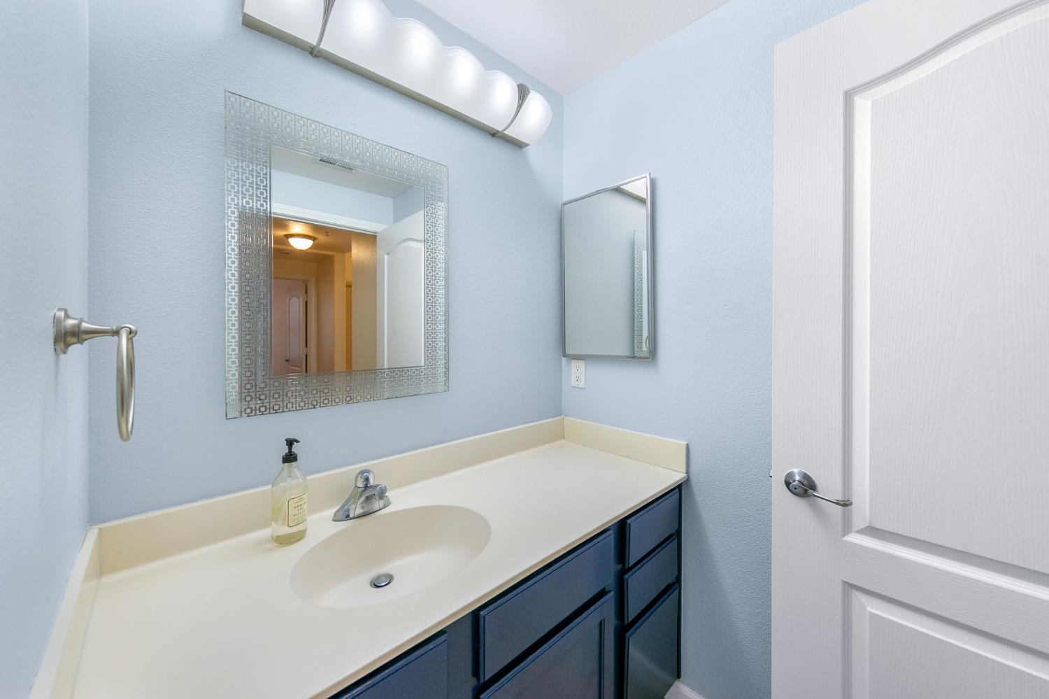 1900 Danbrook Drive, Unit 1222 Sacramento, CA 95835 - Photo 31 of 51 a bathroom with a sink and a mirror