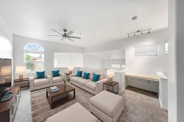 a living room with furniture and a chandelier