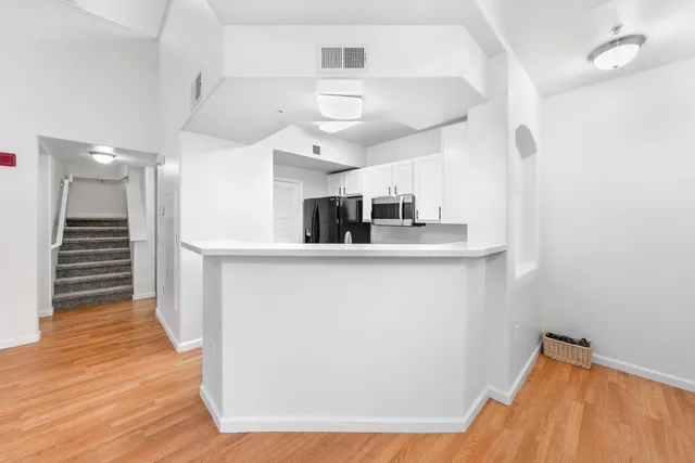 a kitchen with stainless steel appliances a refrigerator and a stove top oven