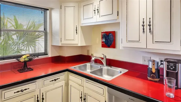 a kitchen with stainless steel appliances granite countertop a sink a cabinets and a window