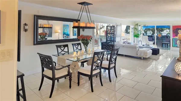 a dining room with furniture a chandelier and window