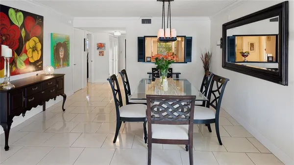 a view of a dining room with furniture and a potted plant