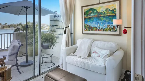a living room with furniture and a floor to ceiling window