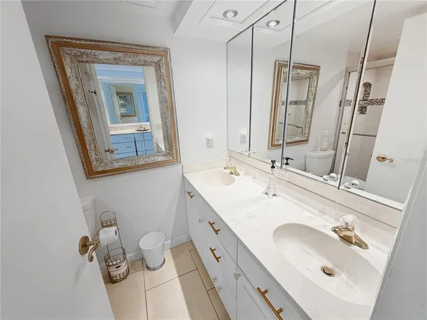a bathroom with a double vanity sink and mirror