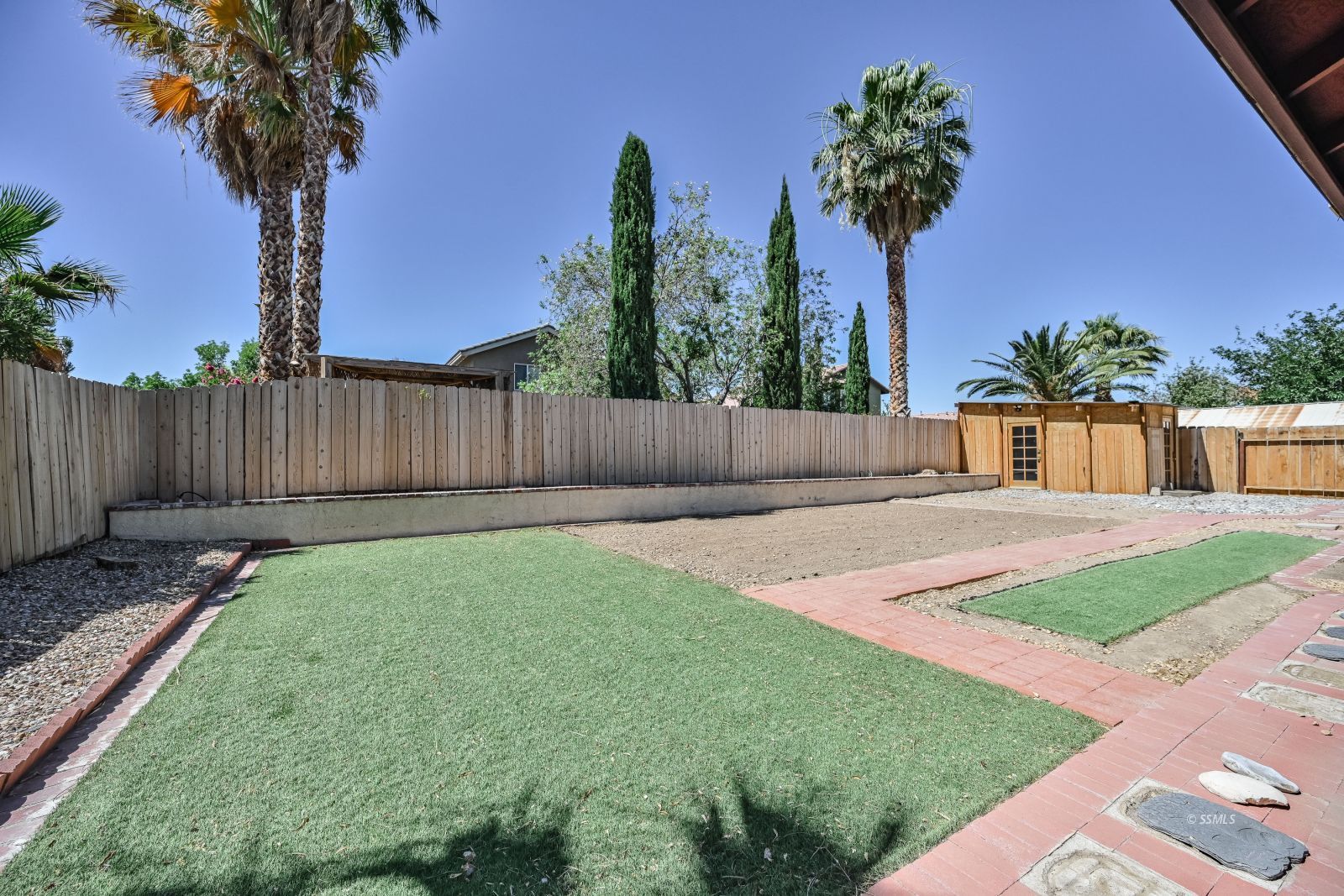 1209 West Robert Avenue Ridgecrest, CA 93555 - Photo 46 of 50 a front view of a house with garden and wooden fence